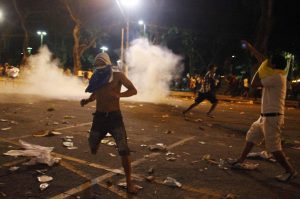 Demonstrators clash with police during an anti-government protest in Belem
