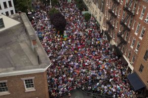 A crowd gathers to listen to speakers near the Stonewall Inn in New York