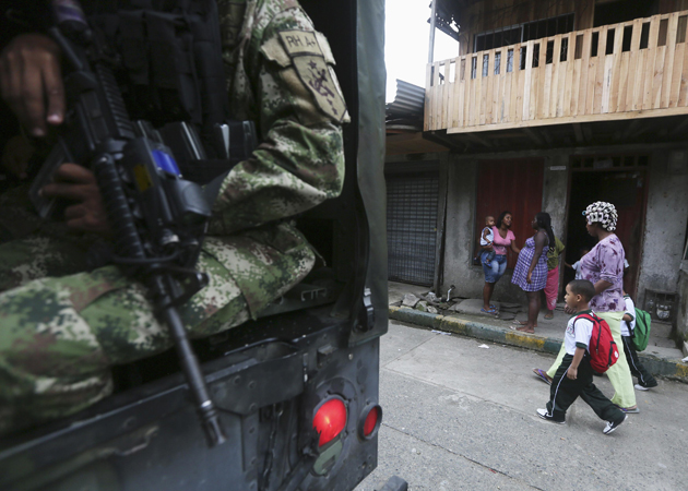 Colombian Special Forces soldier patrols street in "La Playita" neighbourhood, during visit by Defence Minister Juan Carlos Pinzon in Buenaventura