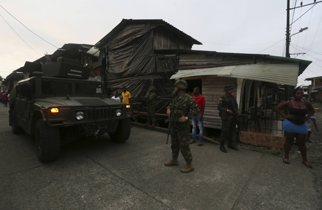 Colombian Special Forces soldiers patrol a street in the "La Playita" neighbourhood, during a visit by Defence Minister Pinzon in the port city of Buenaventura