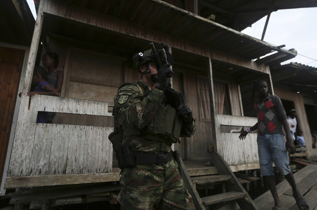A Colombian Special Forces soldier patrols a street in the "La Playita" neighbourhood, during a visit by Defence Minister Pinzon in the port city of Buenaventura