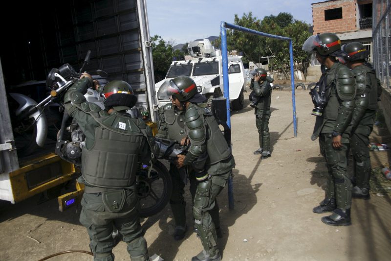 Venezuelan soldiers unload a seized motorcycle from a truck during a special deployment, at San Antonio in Tachira state, Venezuela