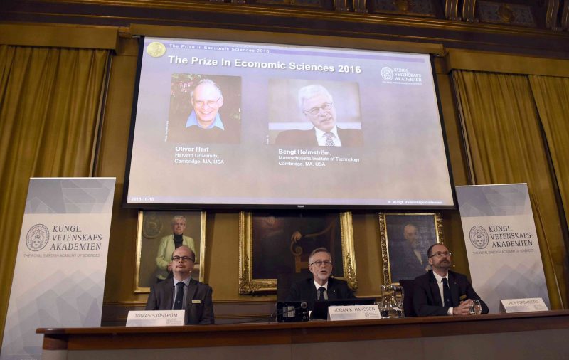 From left, Tomas Sjostrom, member of the Committee for the Prize in Economic Sciences in memory of Alfred Nobel, Goran K. Hansson, Secretary General of the Royal Swedish Academy of Sciences and Per Stromberg, Chairman of the Committee for the Prize in Economic Sciences in memory of Alfred Nobel, attend a press conference to announce Oliver Hart and Bengt Holmstrom as the winners of the Nobel Memorial Prize in economic sciences. (Stina Stjernkvist/TT via AP)