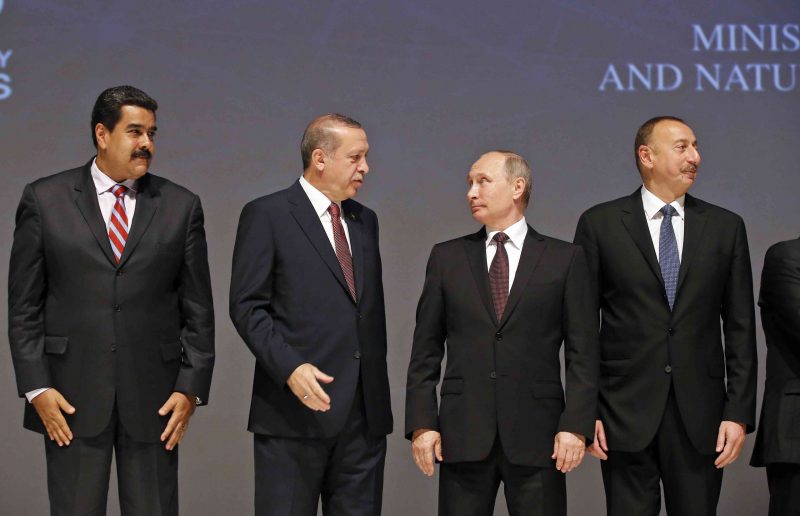 Turkey's President Recep Tayyip Erdogan, 2nd left, talks to Russian President Vladimir Putin, 2nd right, as they set up for the group photo at the World Energy Congress, in Istanbul, Monday, Oct. 10, 2016. Venezuela's President Nicolas Maduro is on the left and  Azerbaijan President Ilham Aliyev is on the right. (AP Photo/Emrah Gurel)