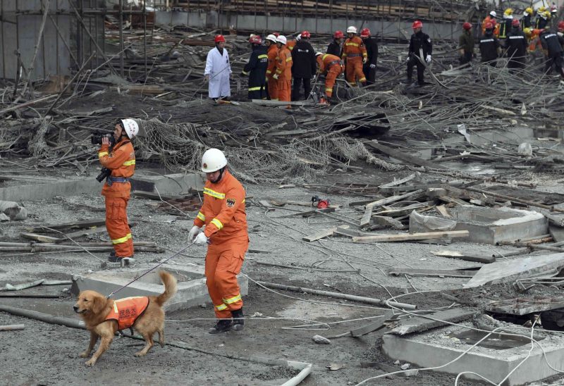 In this photo released by Xinhua News Agency, rescue workers look for survivors after a work platform collapsed at the Fengcheng power plant in eastern China's Jiangxi Province, Nov. 24, 2016. State media reported dozens were killed after the scaffolding tumbled down. (Wan Xiang/Xinhua via AP)